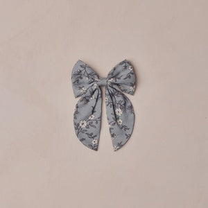 Floral patterned bow on a beige background