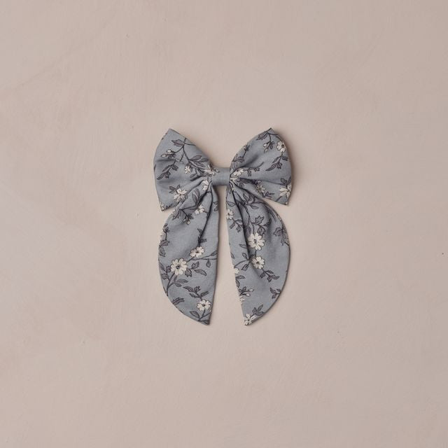 Floral patterned bow on a beige background