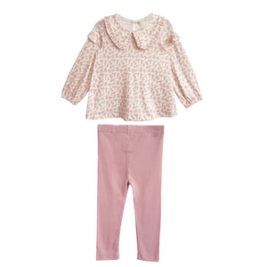 Pink floral top and pants set on a white background