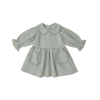 Light fern green dress with ruffled collar on a white background