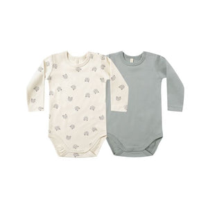 Two baby bodysuits, one cream with a teddy bear face pattern and one steel blue, on a white background.