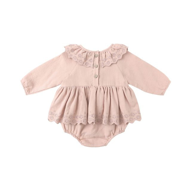 Pink baby romper with lace details on a white background