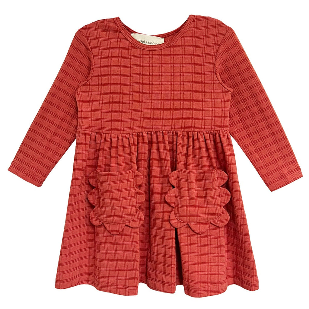 Red checkered dress with scalloped pockets on a white background