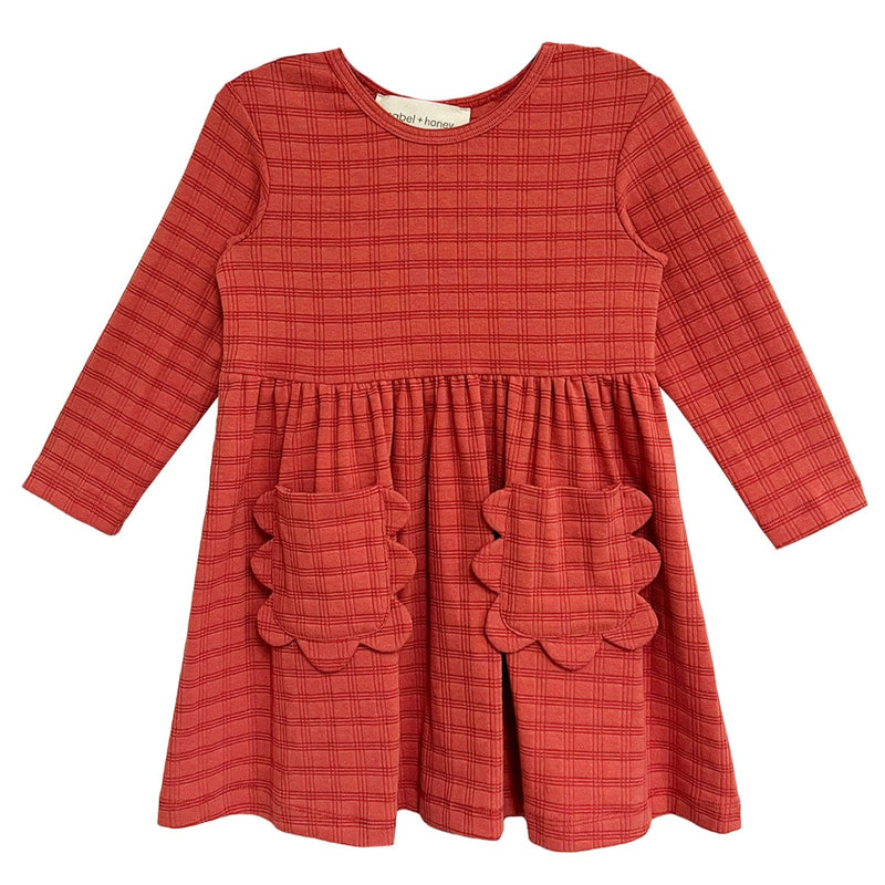 Red checkered dress with scalloped pockets on a white background