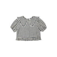Navy and white checkered blouse with ruffled collar on a white background
