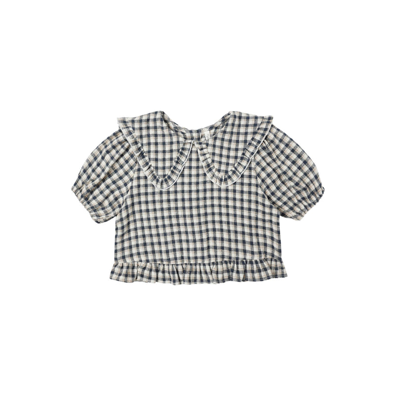 Navy and white checkered blouse with ruffled collar on a white background