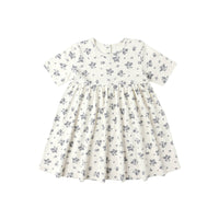 White dress with blue floral pattern on a white background
