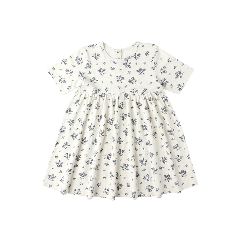 White dress with blue floral pattern on a white background