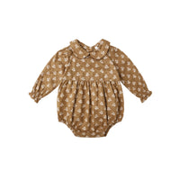 Golden floral baby romper on a white background