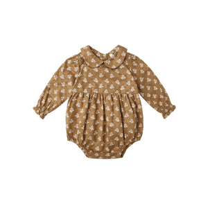 Golden floral baby romper on a white background