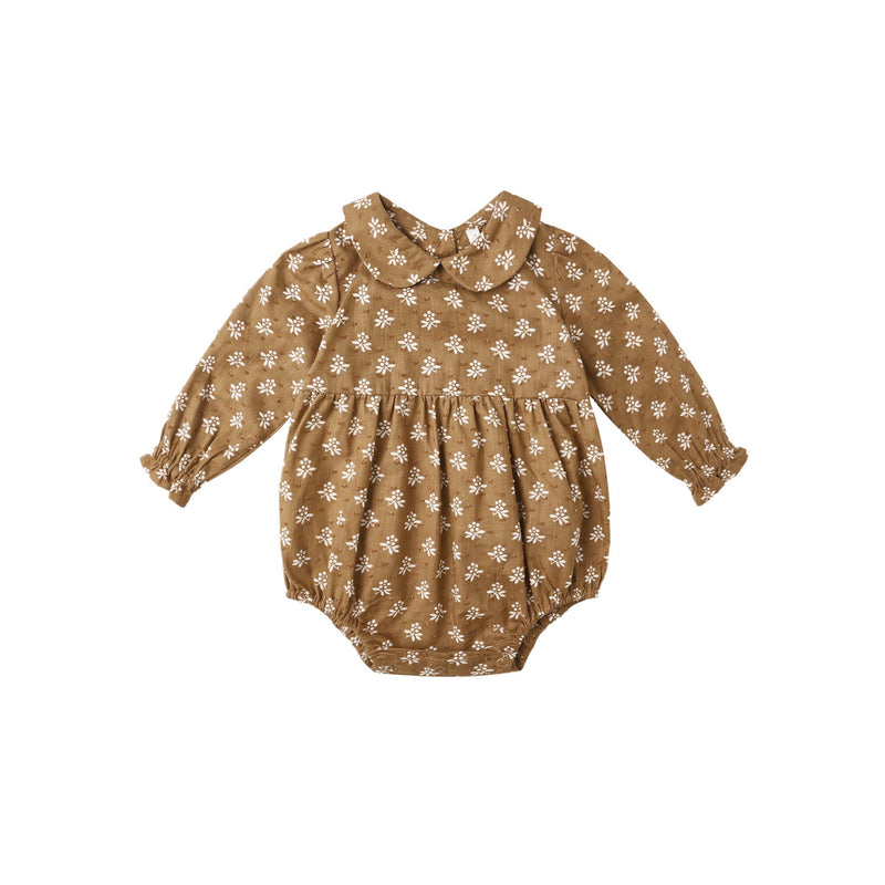 Golden floral baby romper on a white background