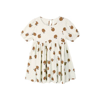 White dress with golden apples pattern on a white background