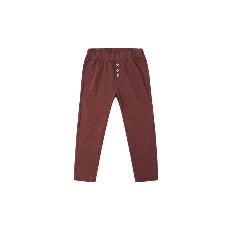 Maroon pants with button details on a white background