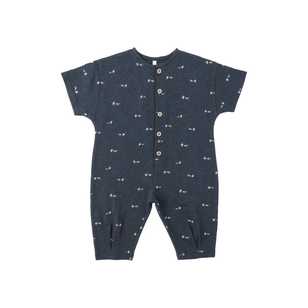 Navy baby romper with white shooting stars pattern on a white background