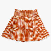 Orange and white gingham skirt on a light beige background