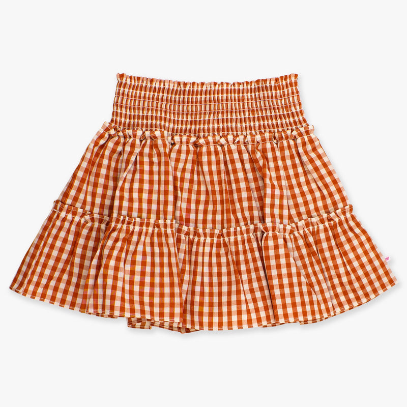 Orange and white gingham skirt on a light beige background
